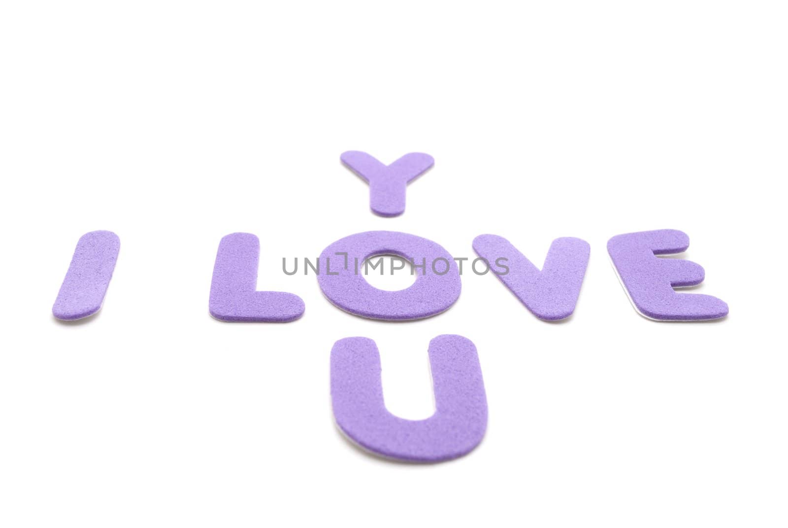 The words 'I love you' spelled out in mauve or purple foam lettering against a white background.