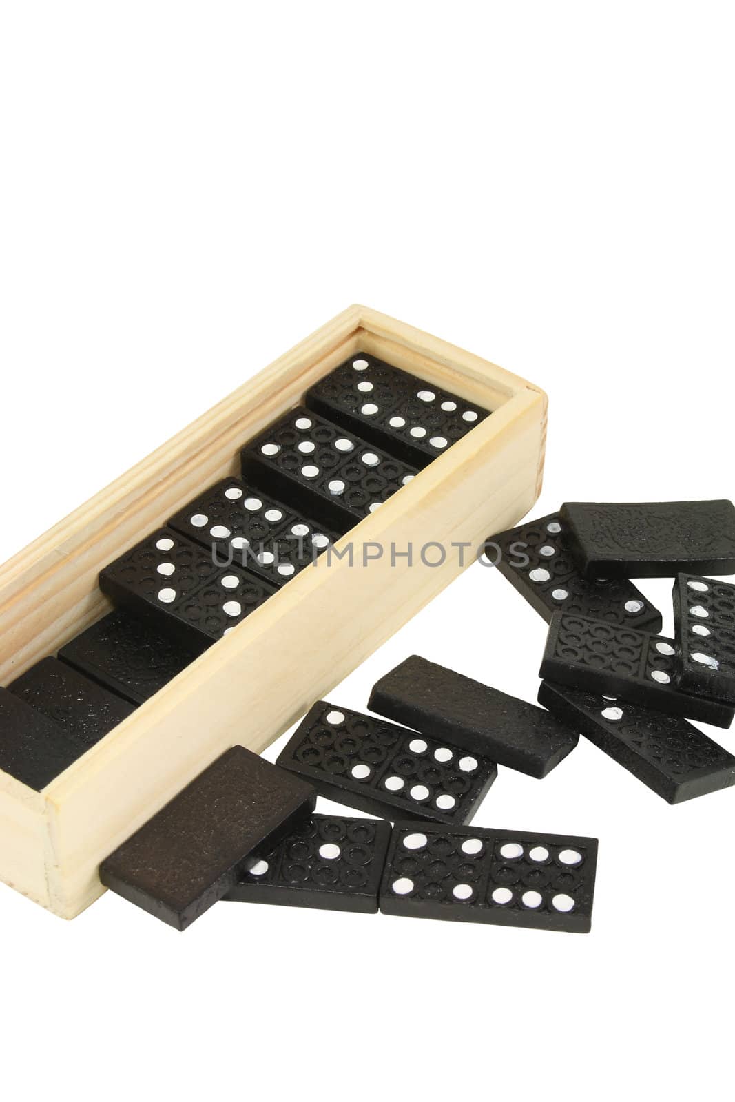a box of domino tiles and scattered tiles isolated
