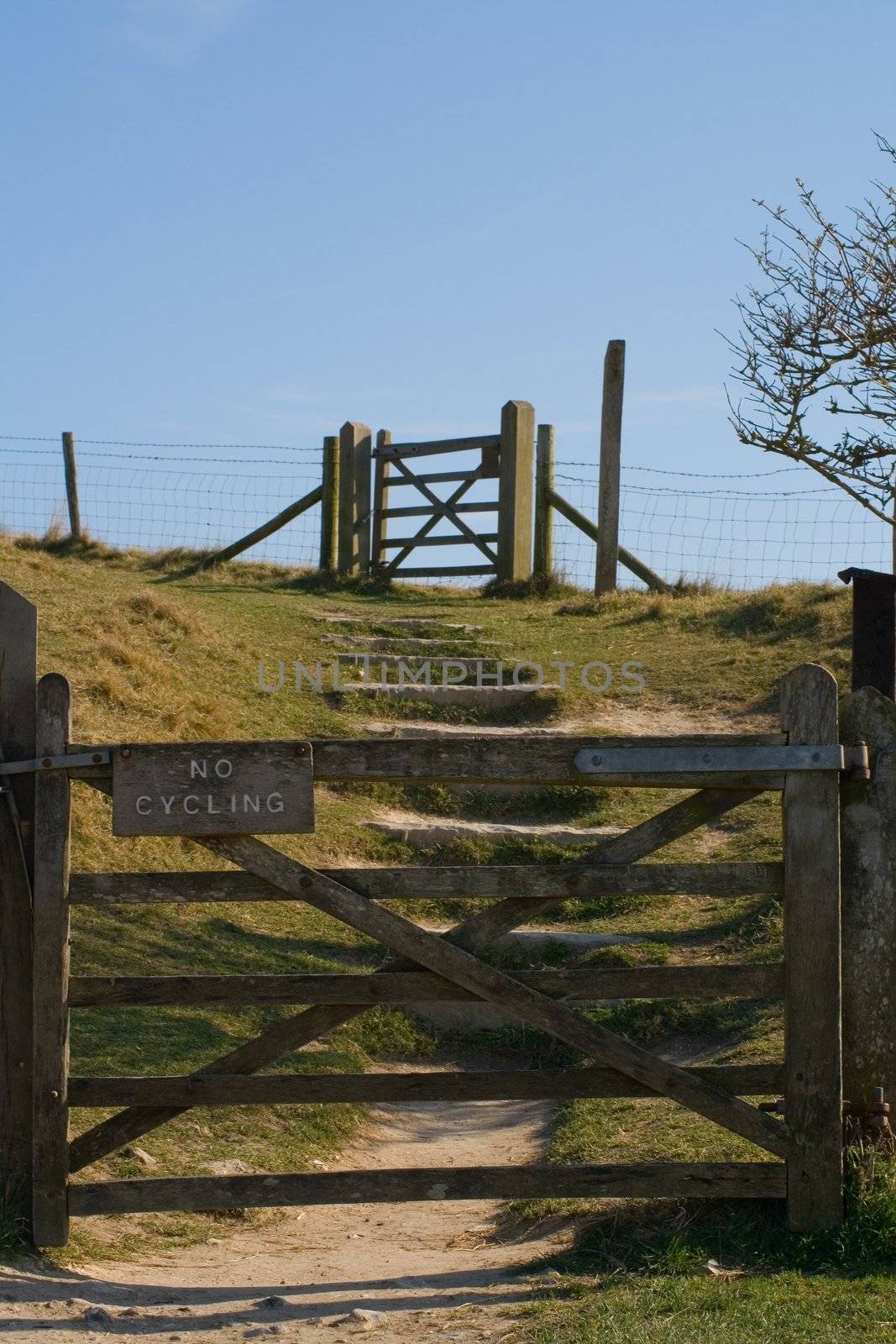 a wooden gate with a sign on it saying 'no cycling'