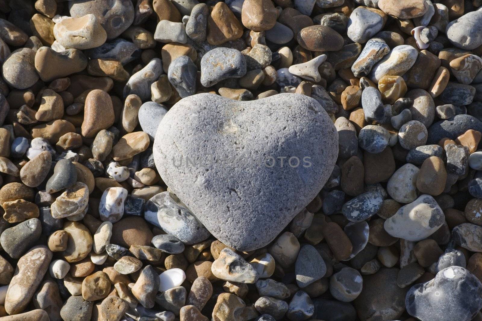 A heart shaped stone on the a beach