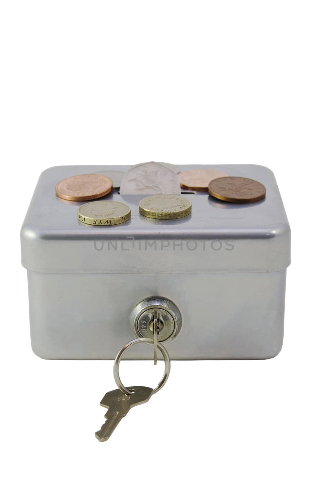 A lockable silver money box closed with some money of top of it