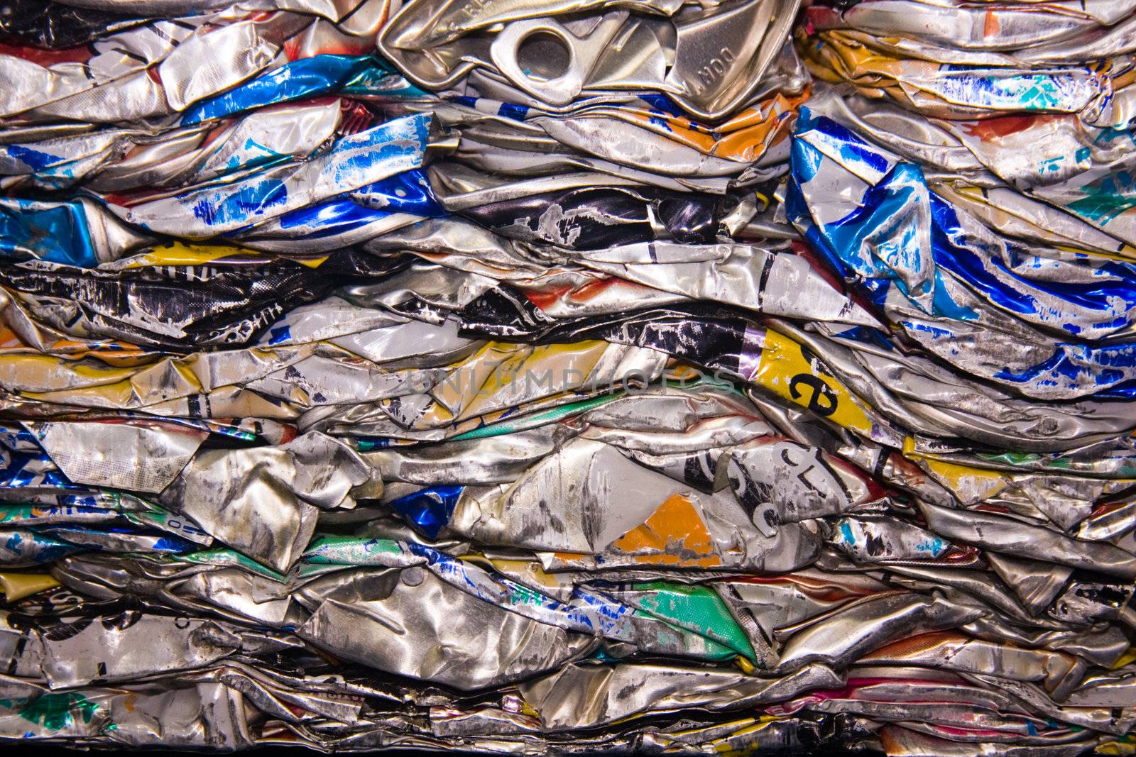 a close up of metal drink cans squashed for recycling