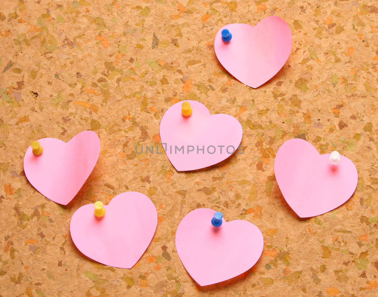 Cork board with heart shape sticky notes
