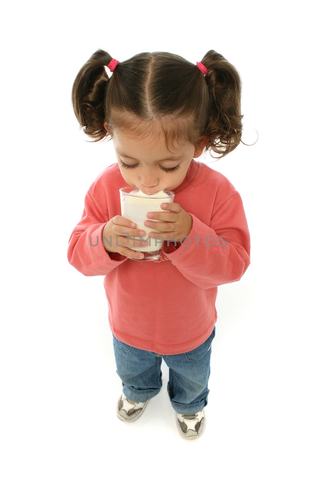 Toddler enjoying a glass of fresh milk