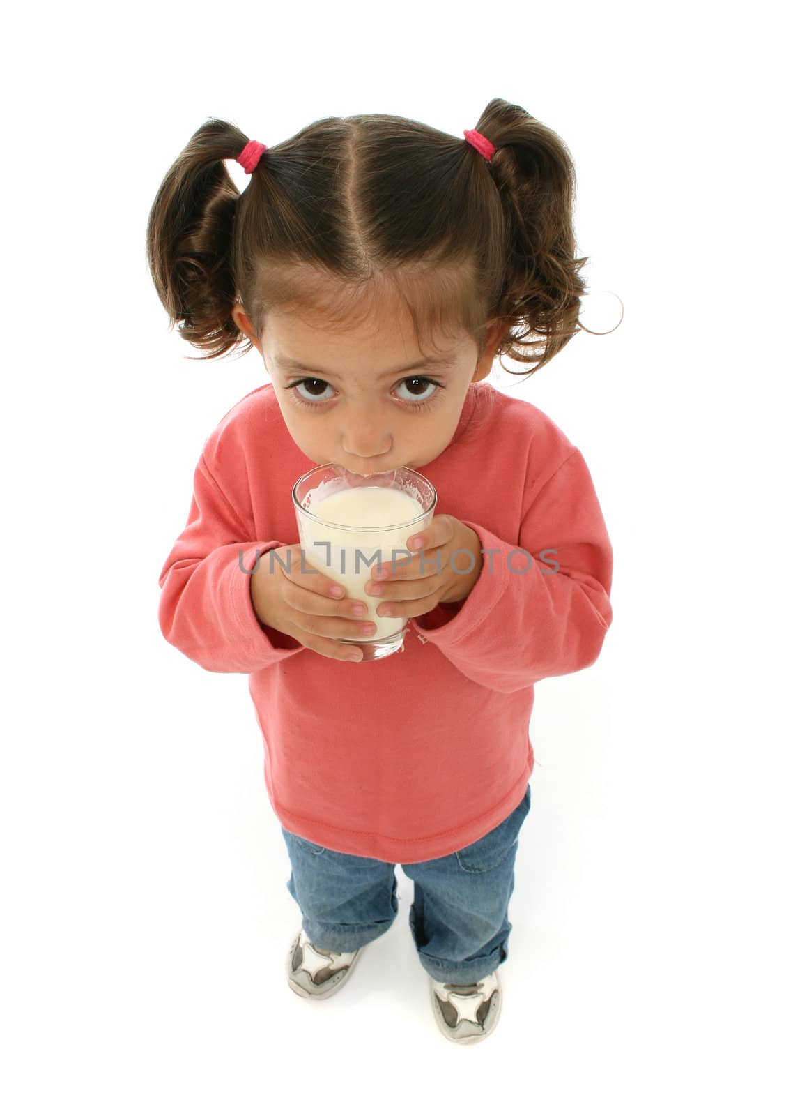 Toddler enjoying a glass of fresh milk