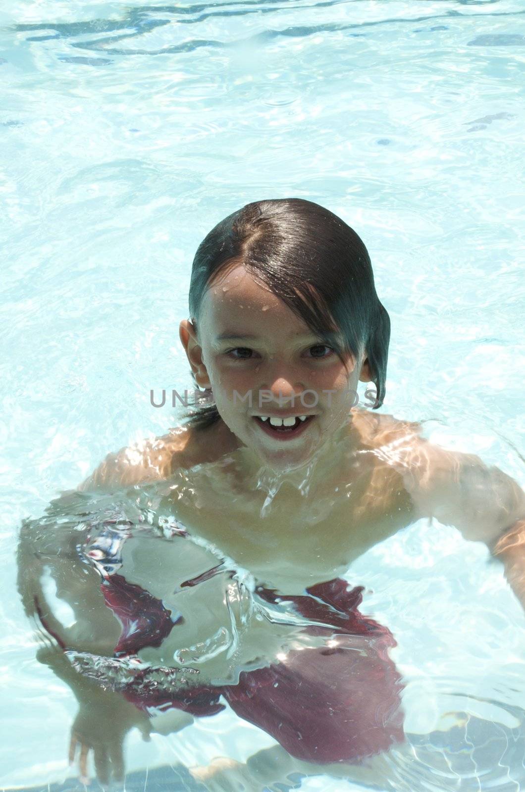 Little boy playing at pool