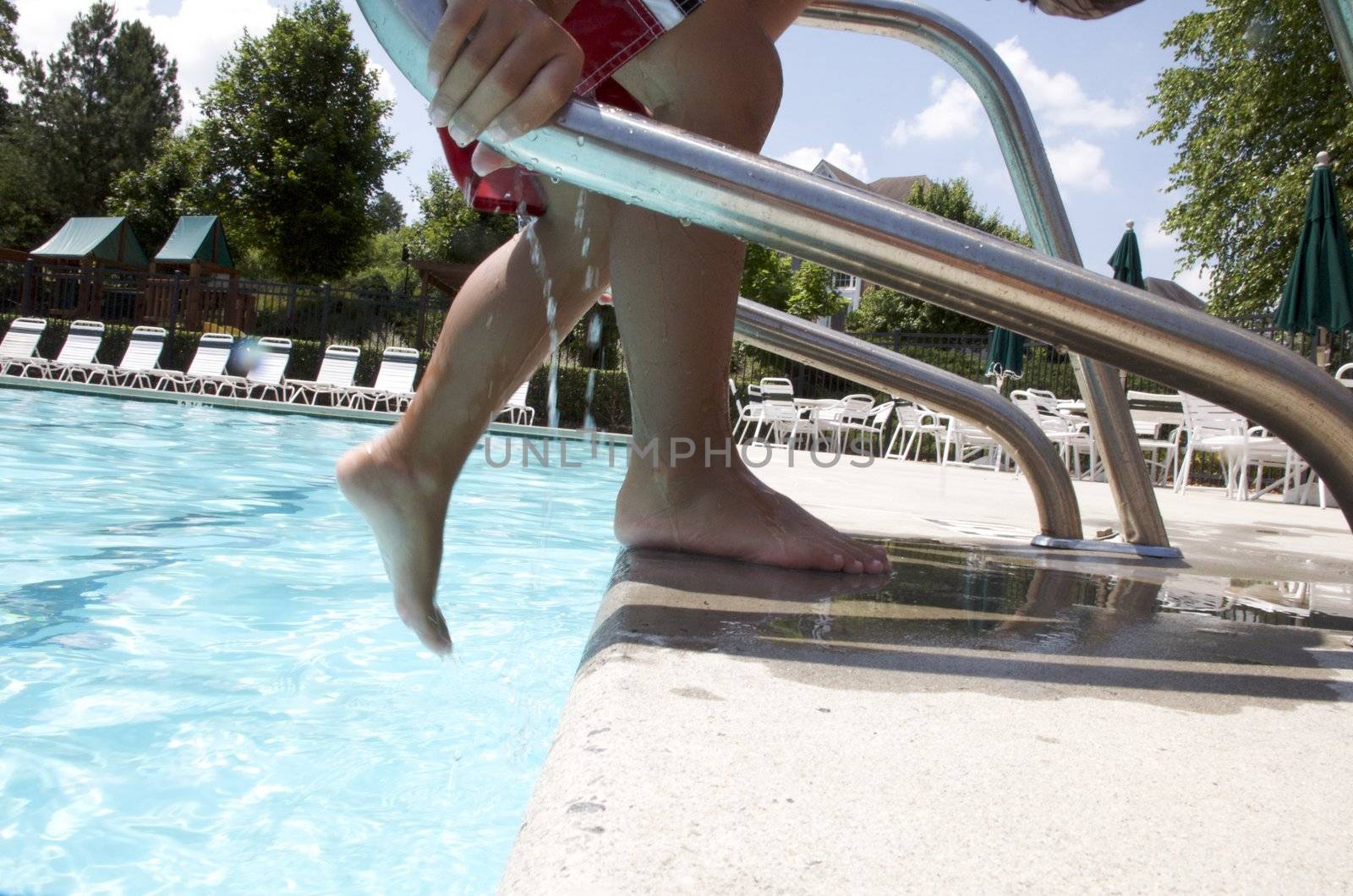 Little boy having fun at neighborhood pool by jedphoto