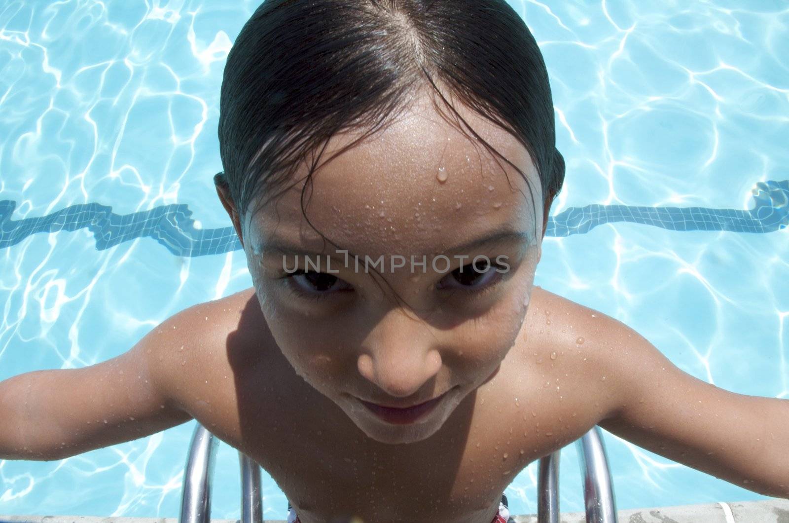 Little boy having fun at neighborhood pool by jedphoto