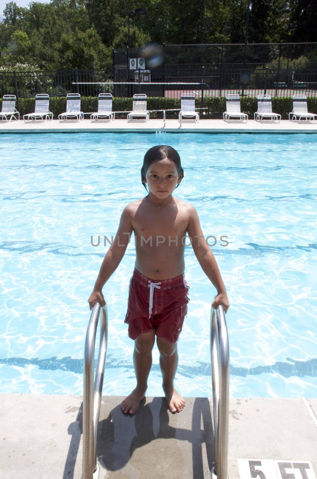 Little boy playing at pool