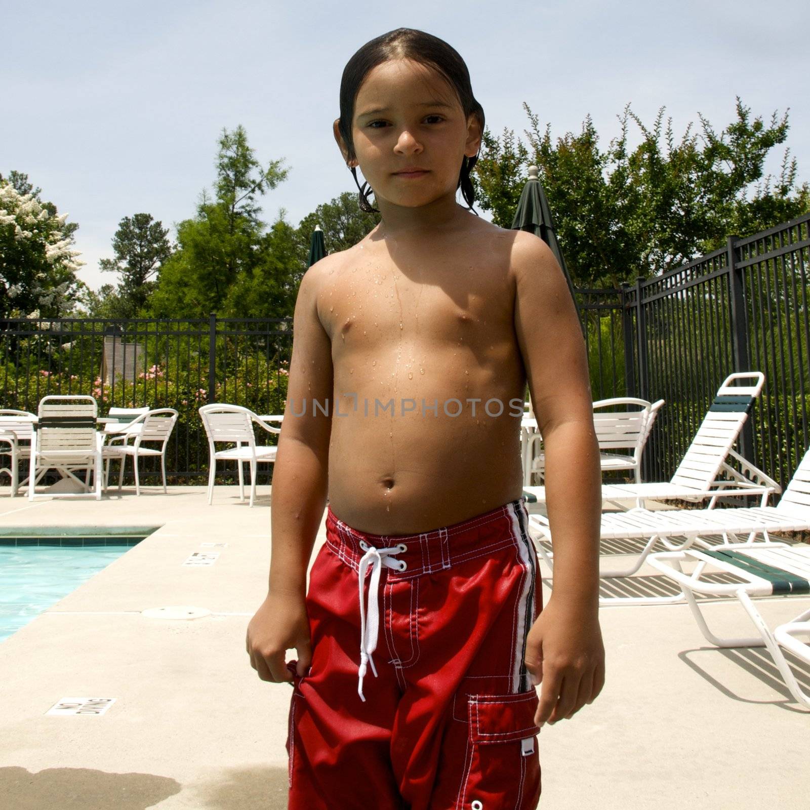 Little boy having fun at neighborhood pool by jedphoto