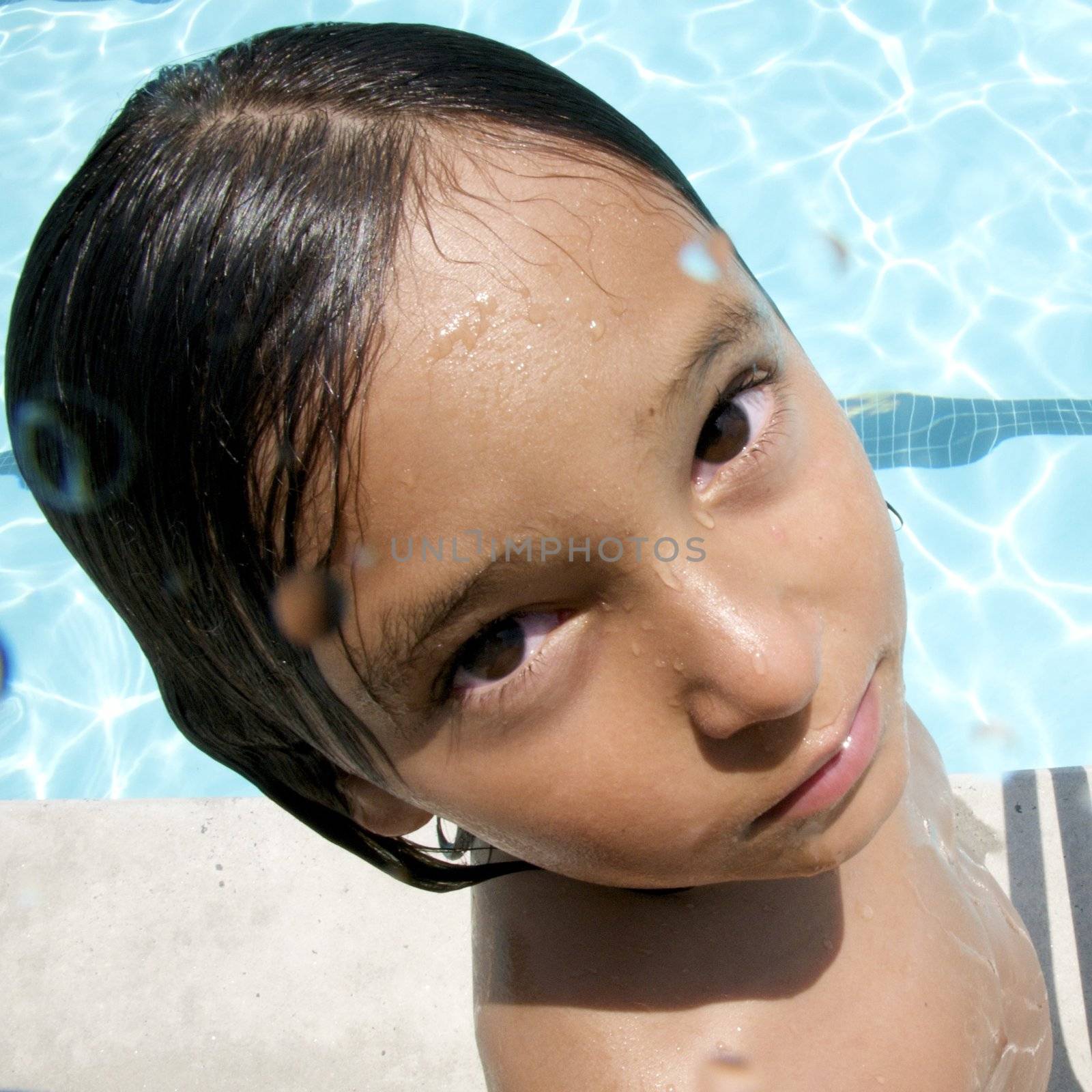 Little boy playing at pool