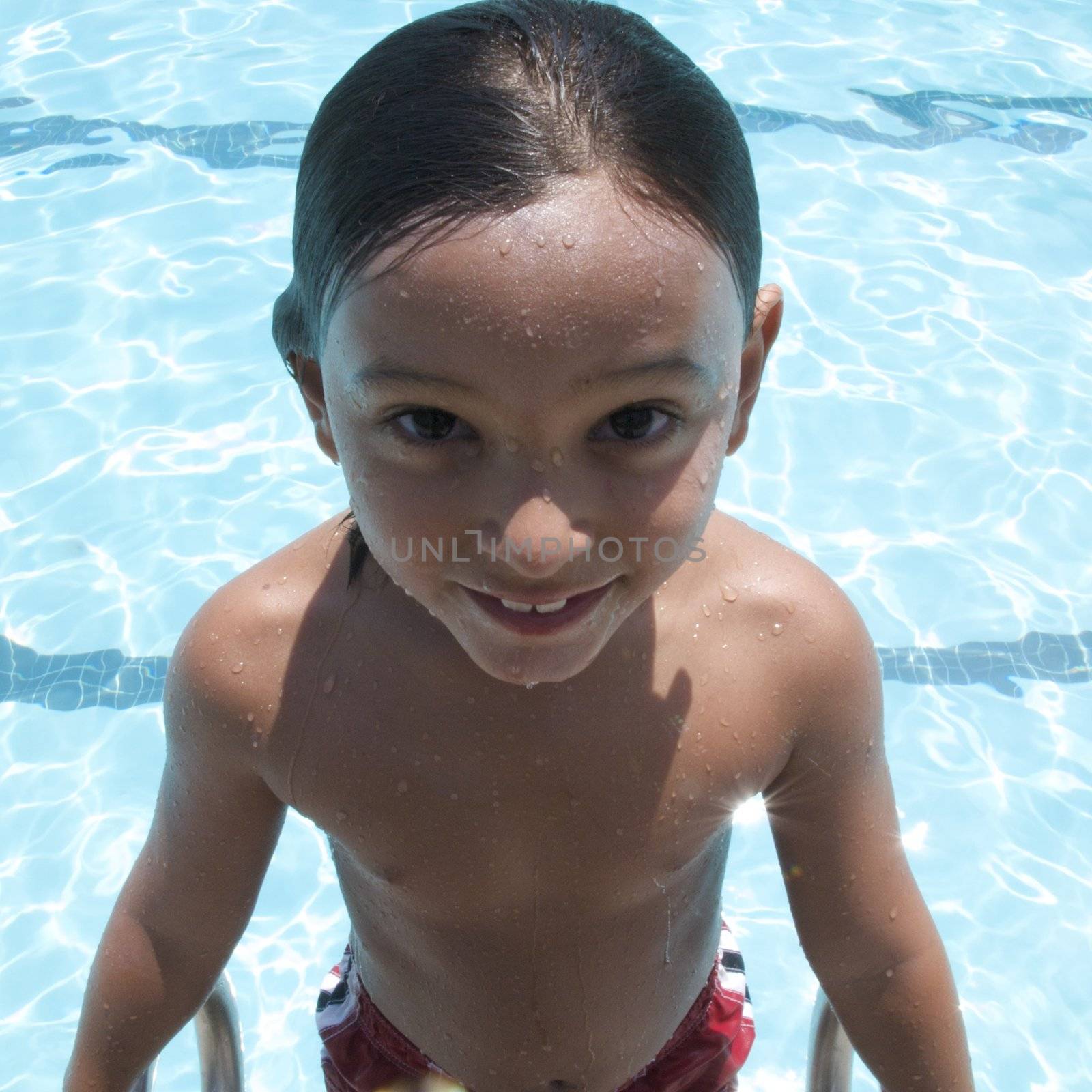 Little boy playing at pool