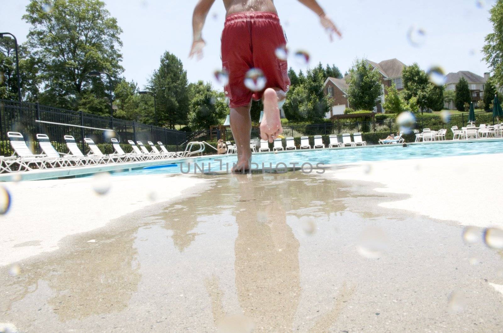 Little boy jumping into pool