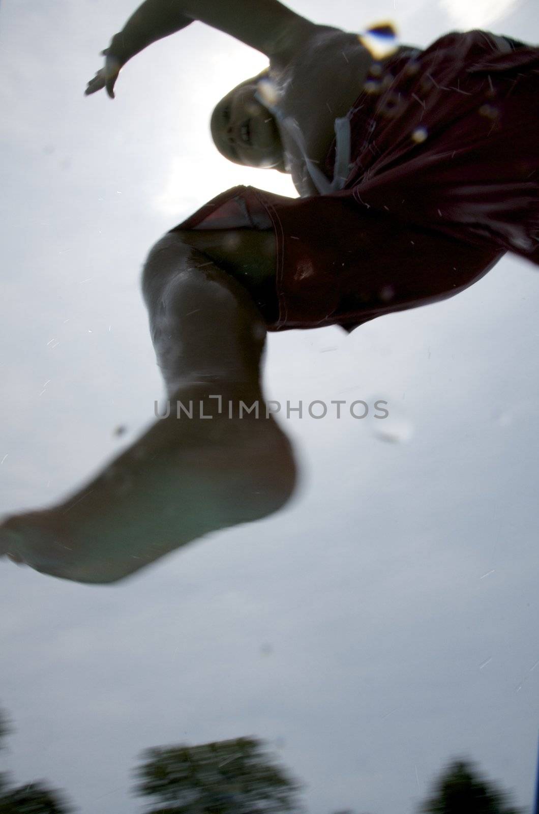 Little boy jumping into pool