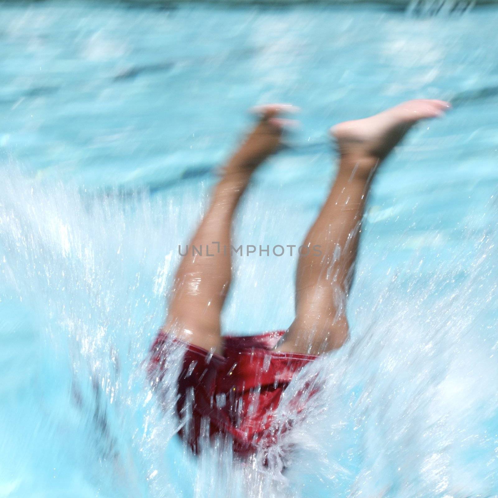 Little boy jumping into pool by jedphoto