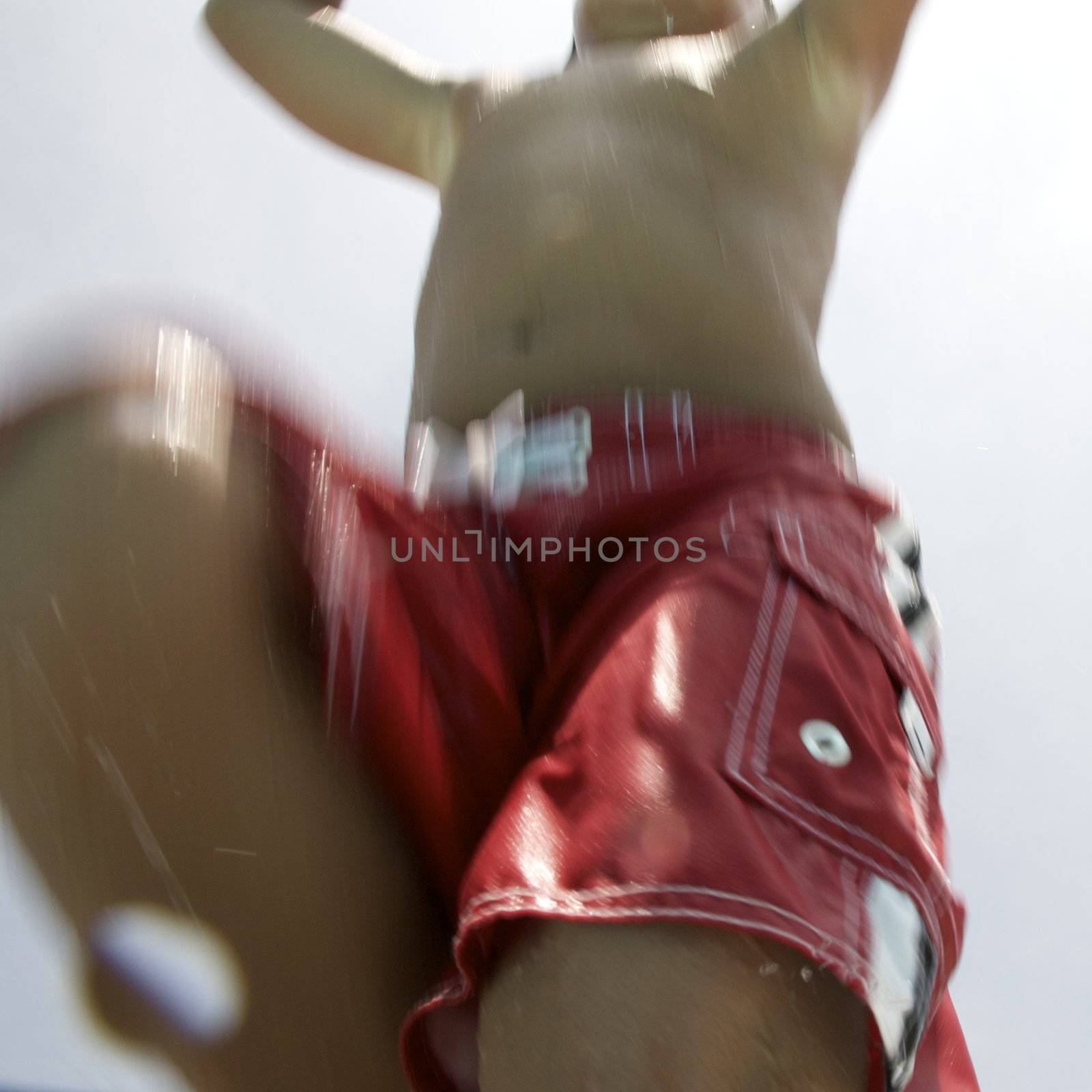 Little boy jumping into pool by jedphoto