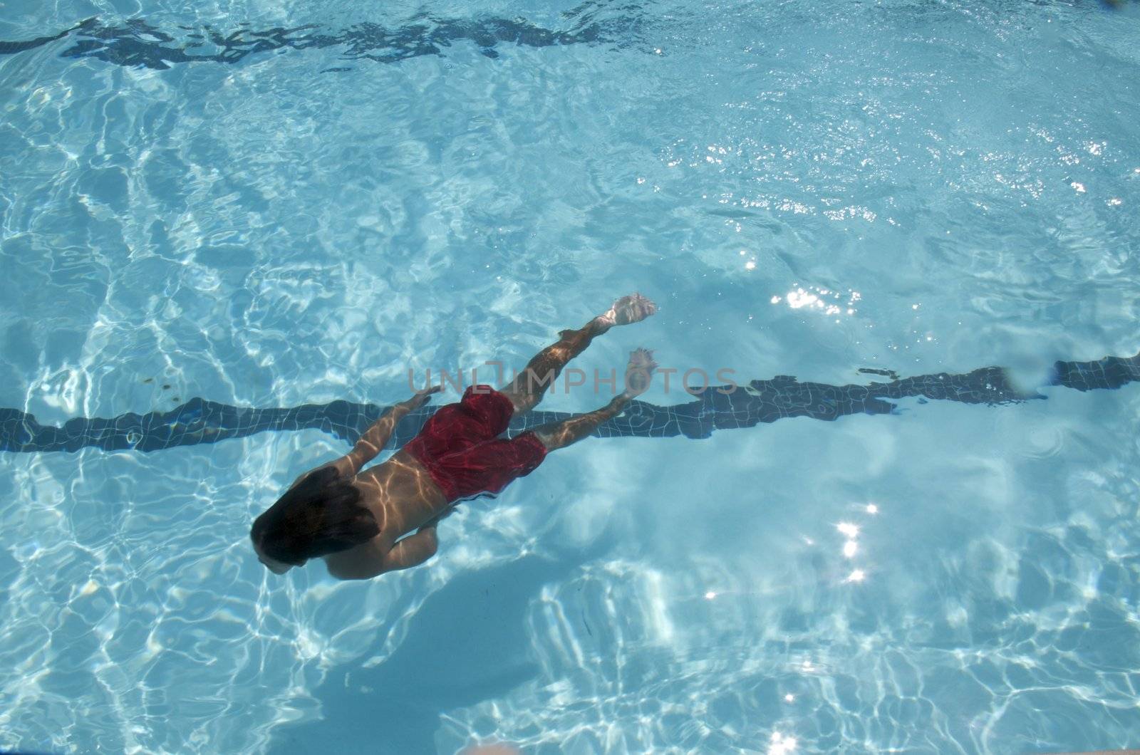 Little boy learning to swim