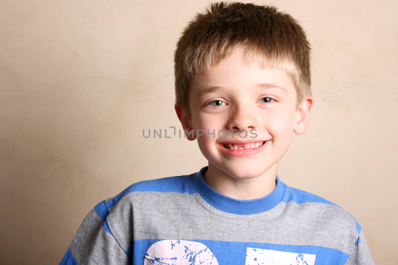 Friendly boy with a blue shirt against a light background