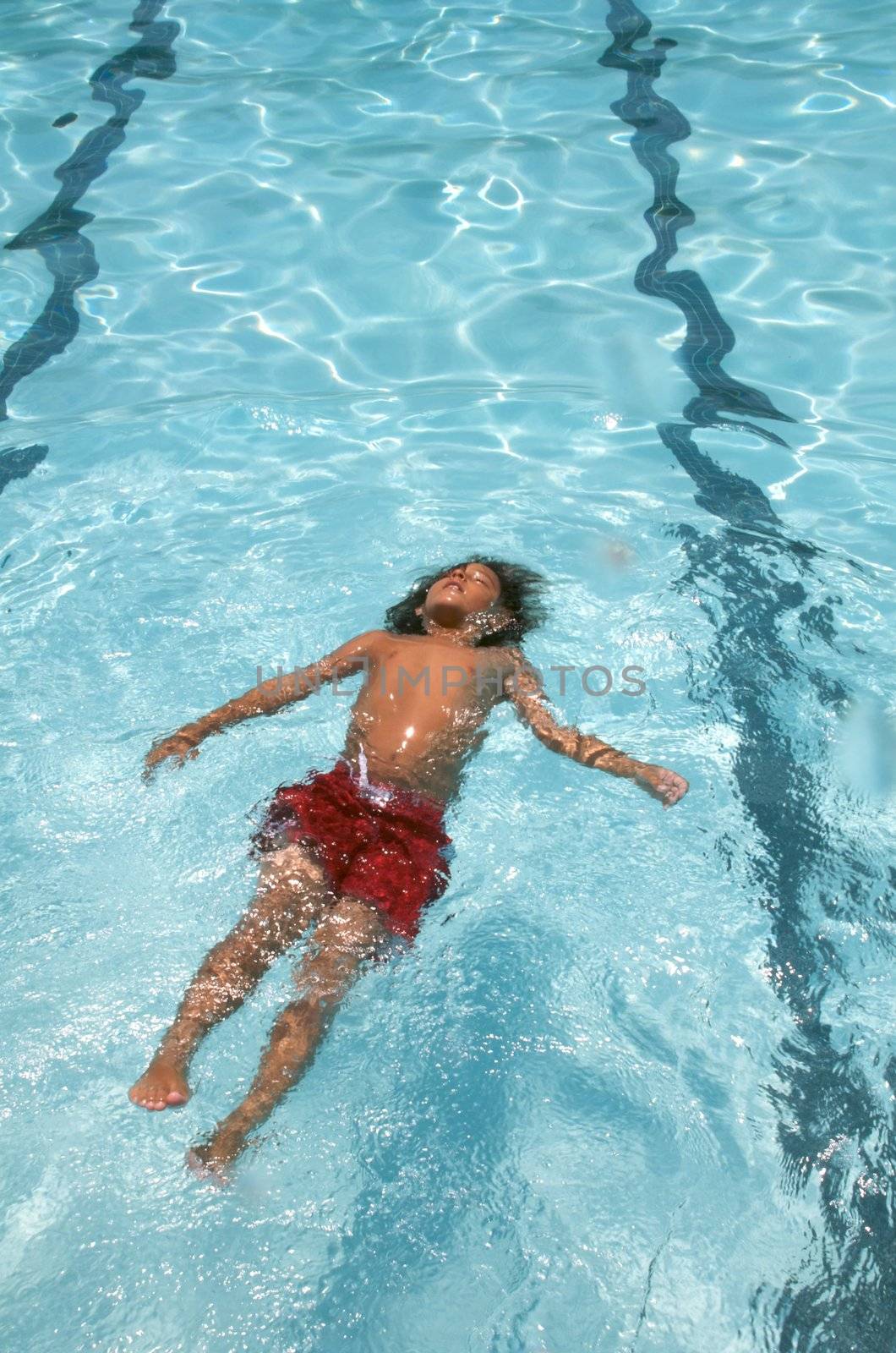 Little boy learning to swim