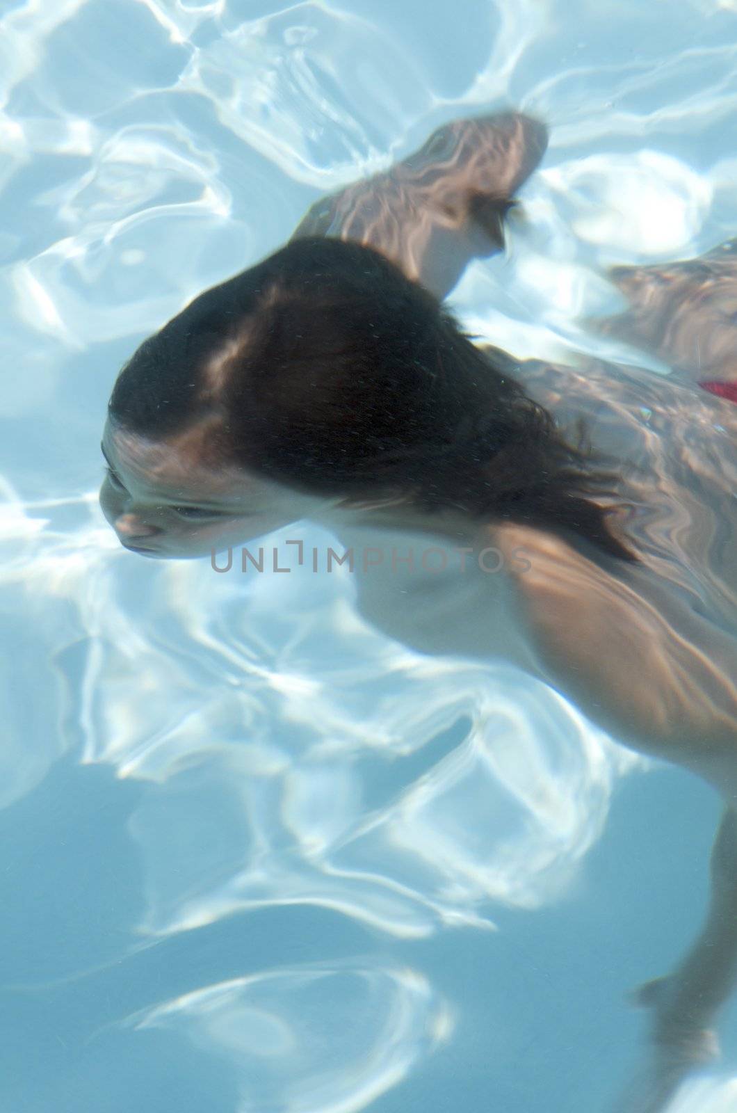 Little boy learning to swim