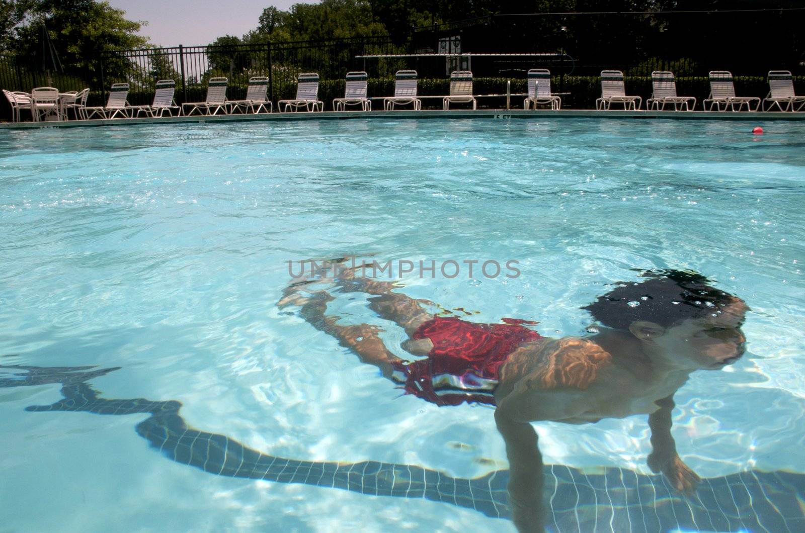Little boy learning to swim