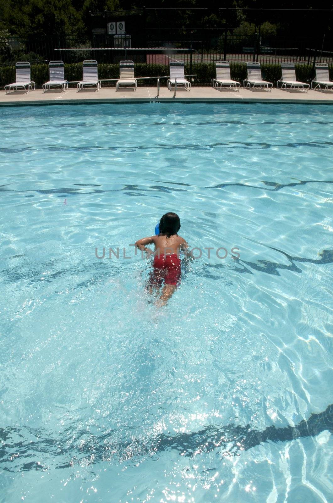 Little boy learning to swim