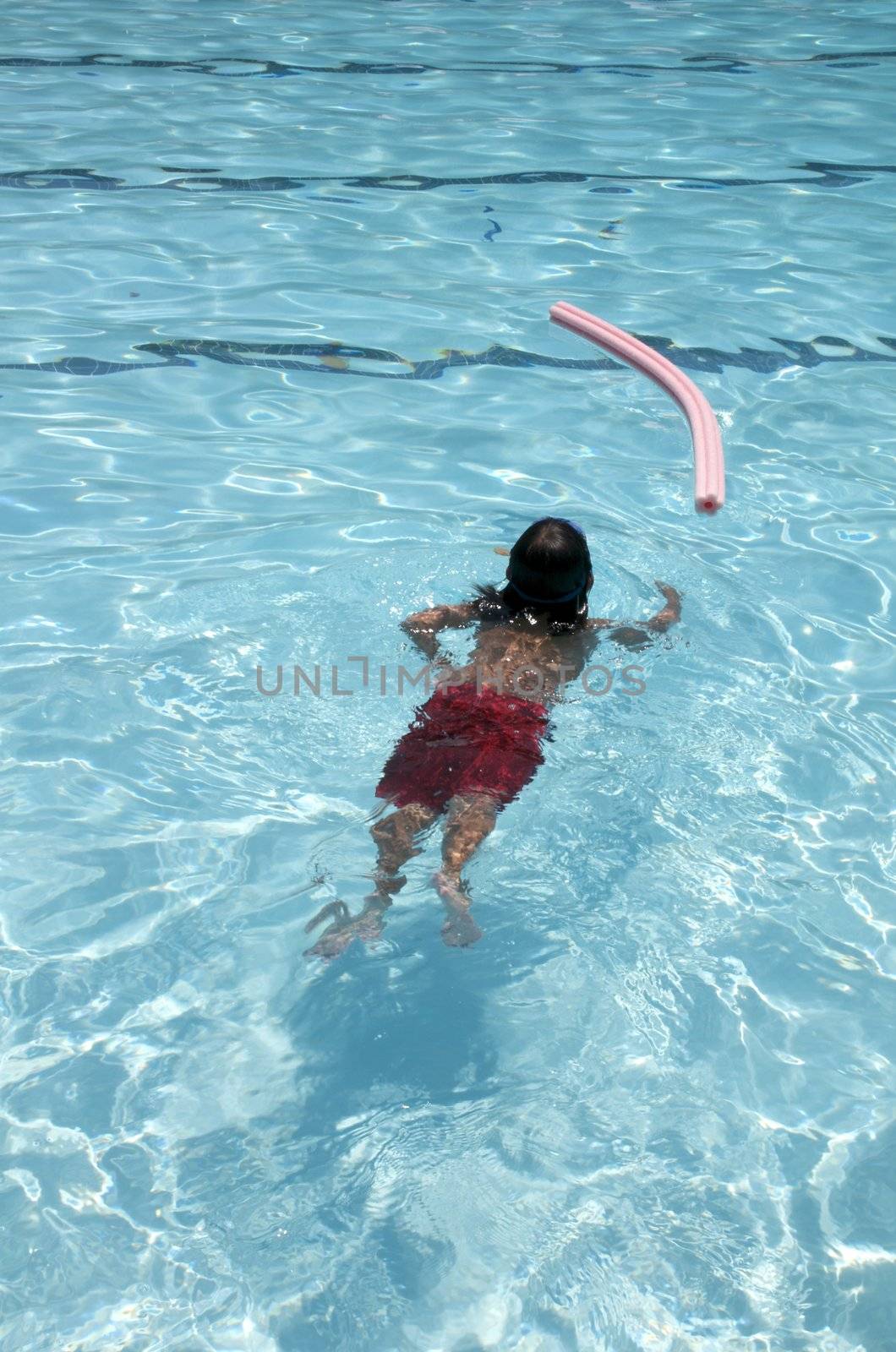 Little boy learning to swim