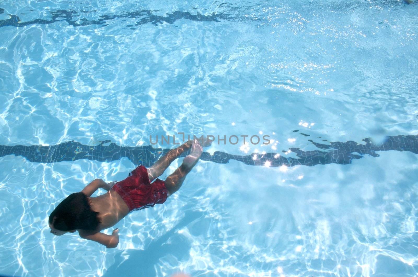 Little boy learning to swim