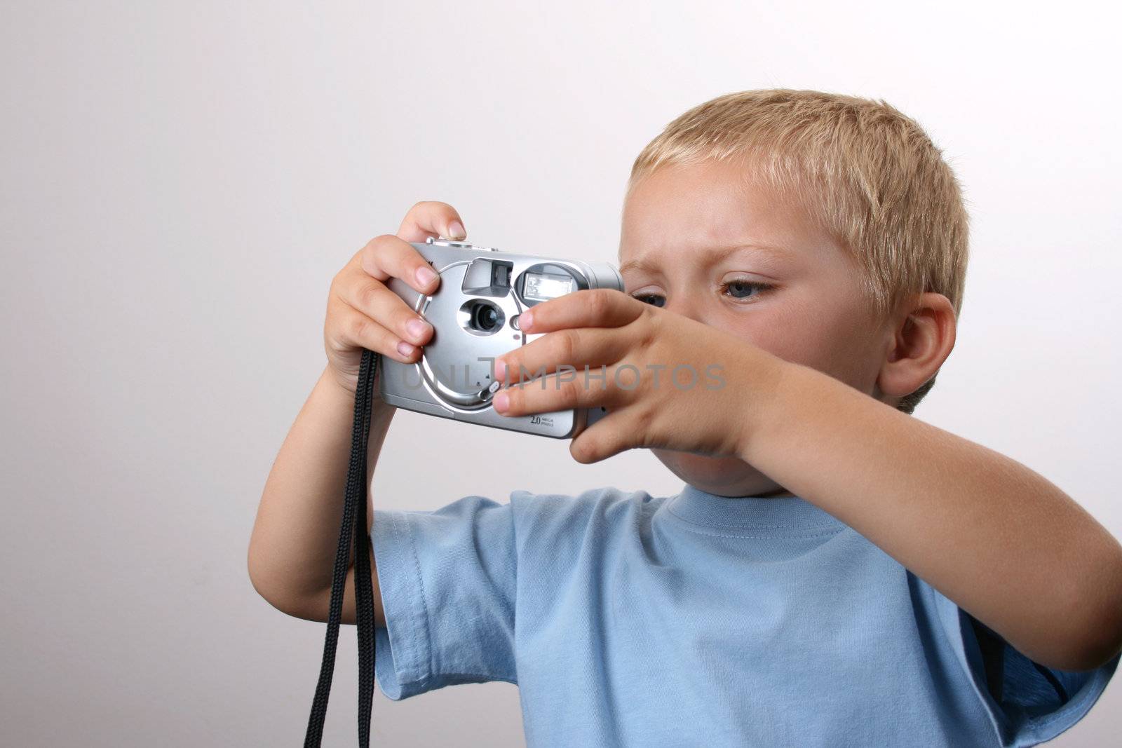Toddler boy playing with a camera