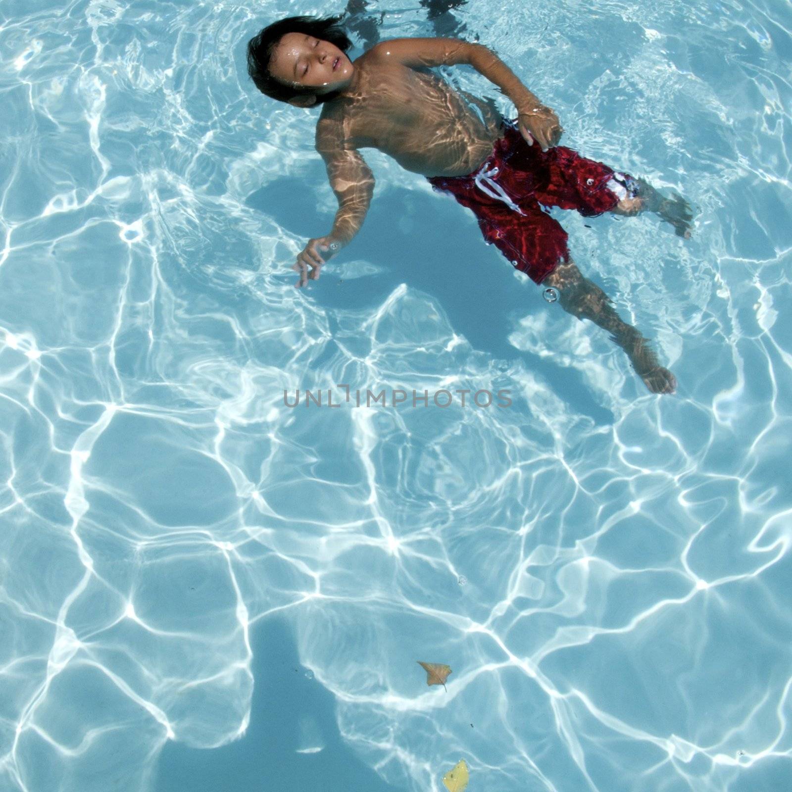 Little boy learning to swim