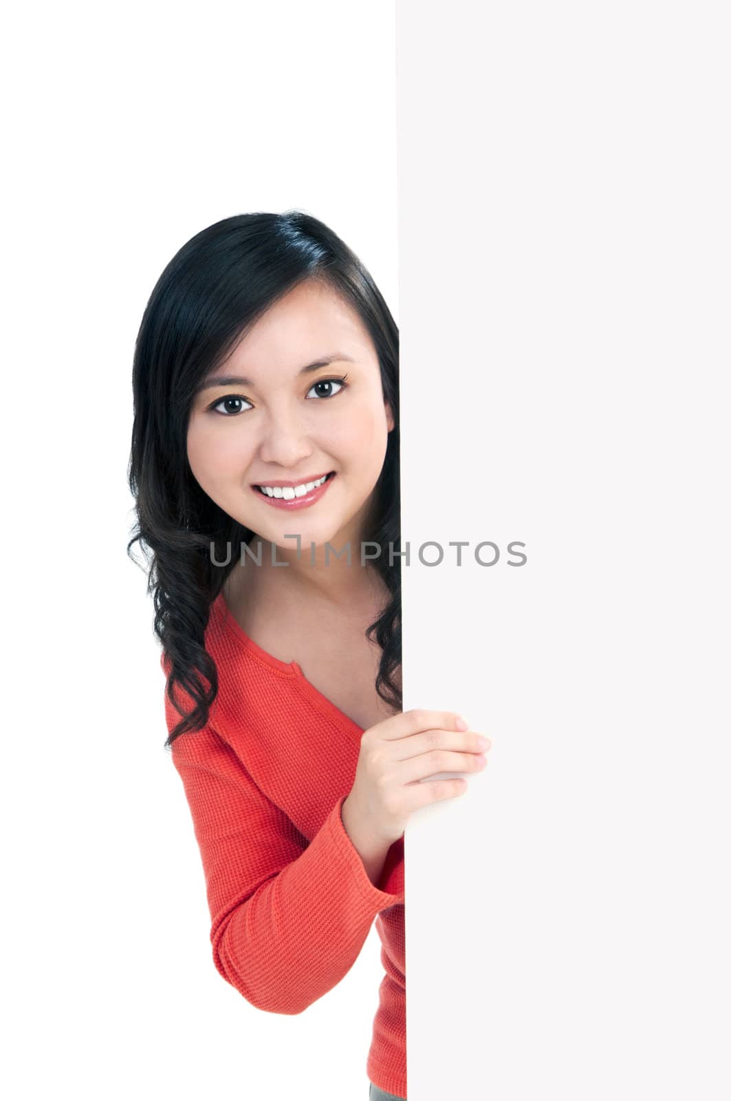 Portrait of an attractive young woman holding a billboard, over white background.