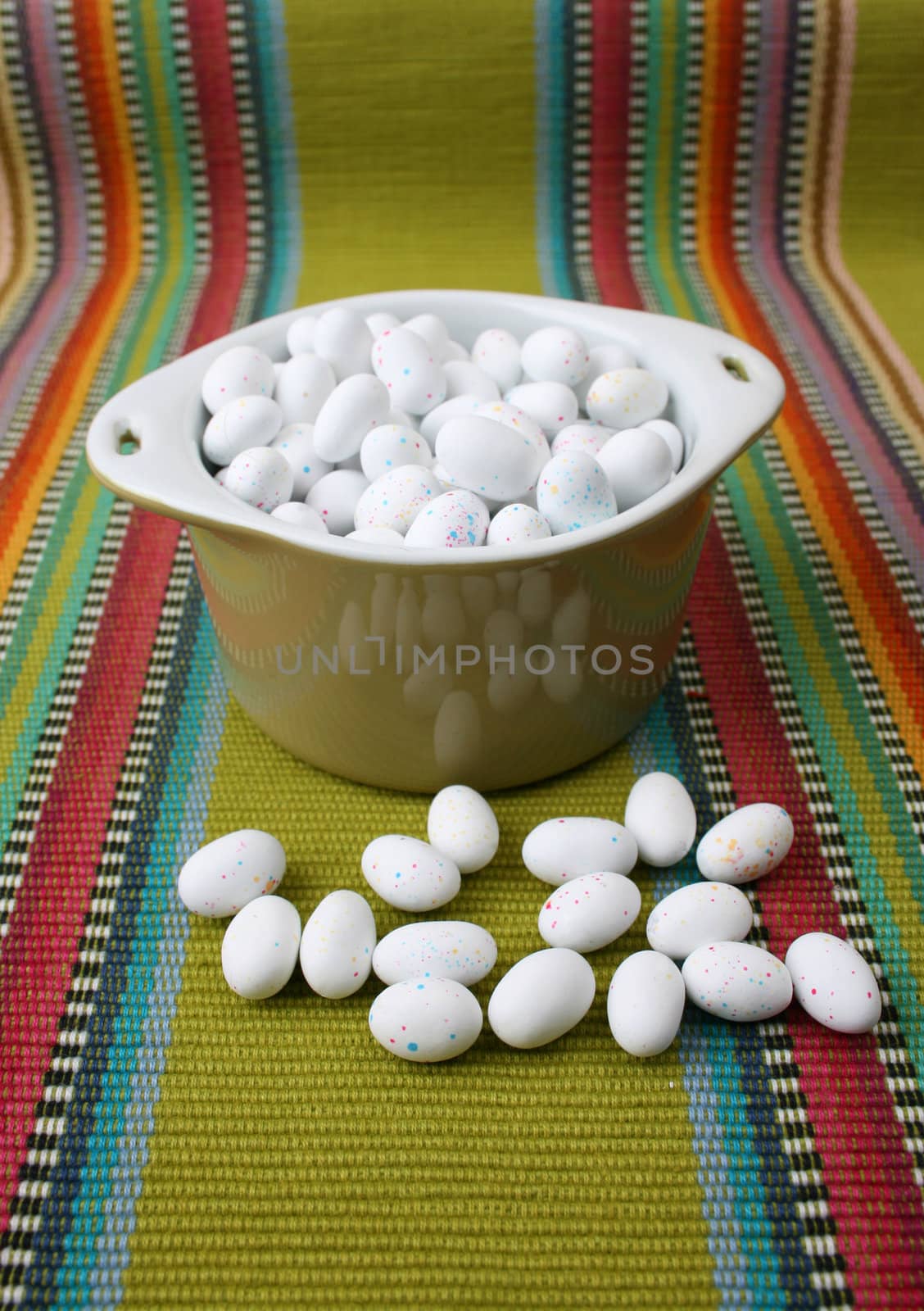 Miniature speckled easter eggs in a green bowl
