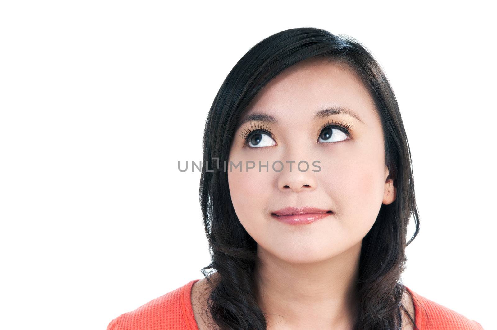 Close-up portrait of a beautiful young woman looking up, over white background.