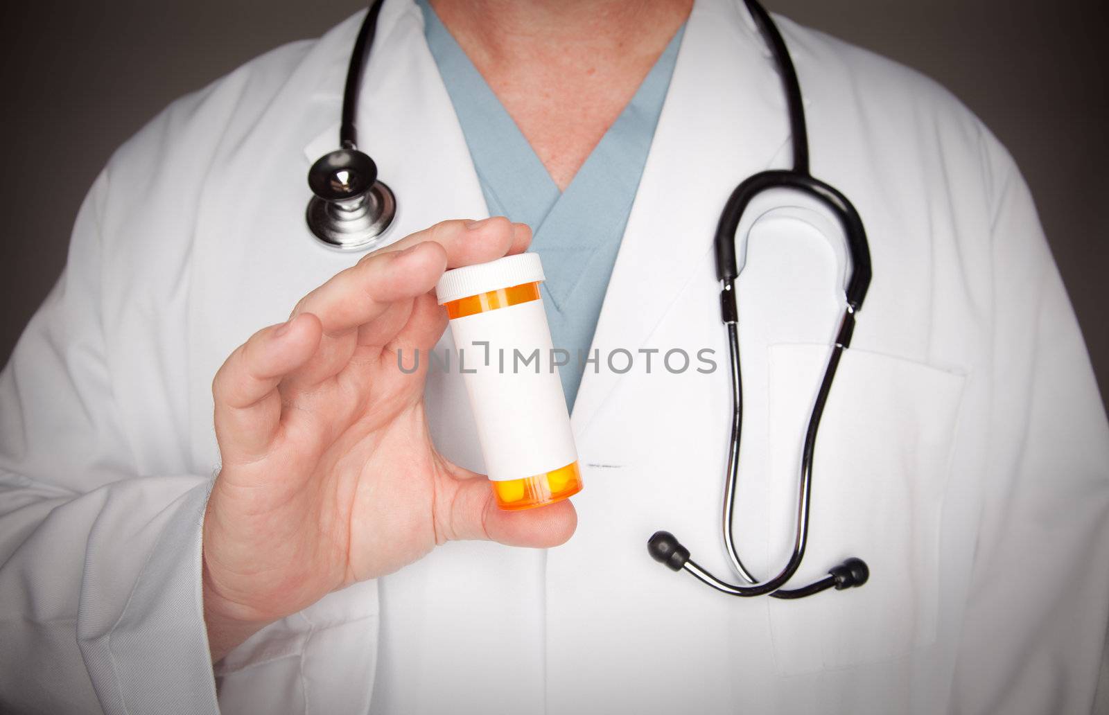 Male Doctor with Stethoscope and Blank Medicine Bottle.