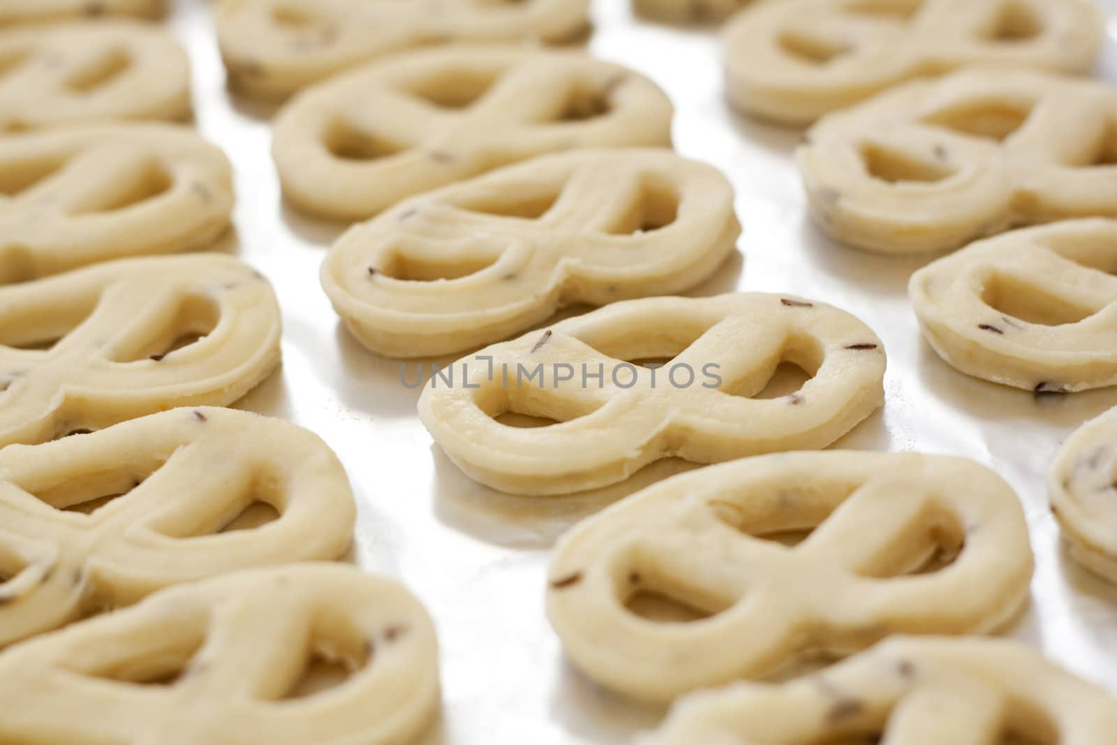 Cookies on aluminum foil ready to be baked. Shallow DOF, focus on selected cookie.