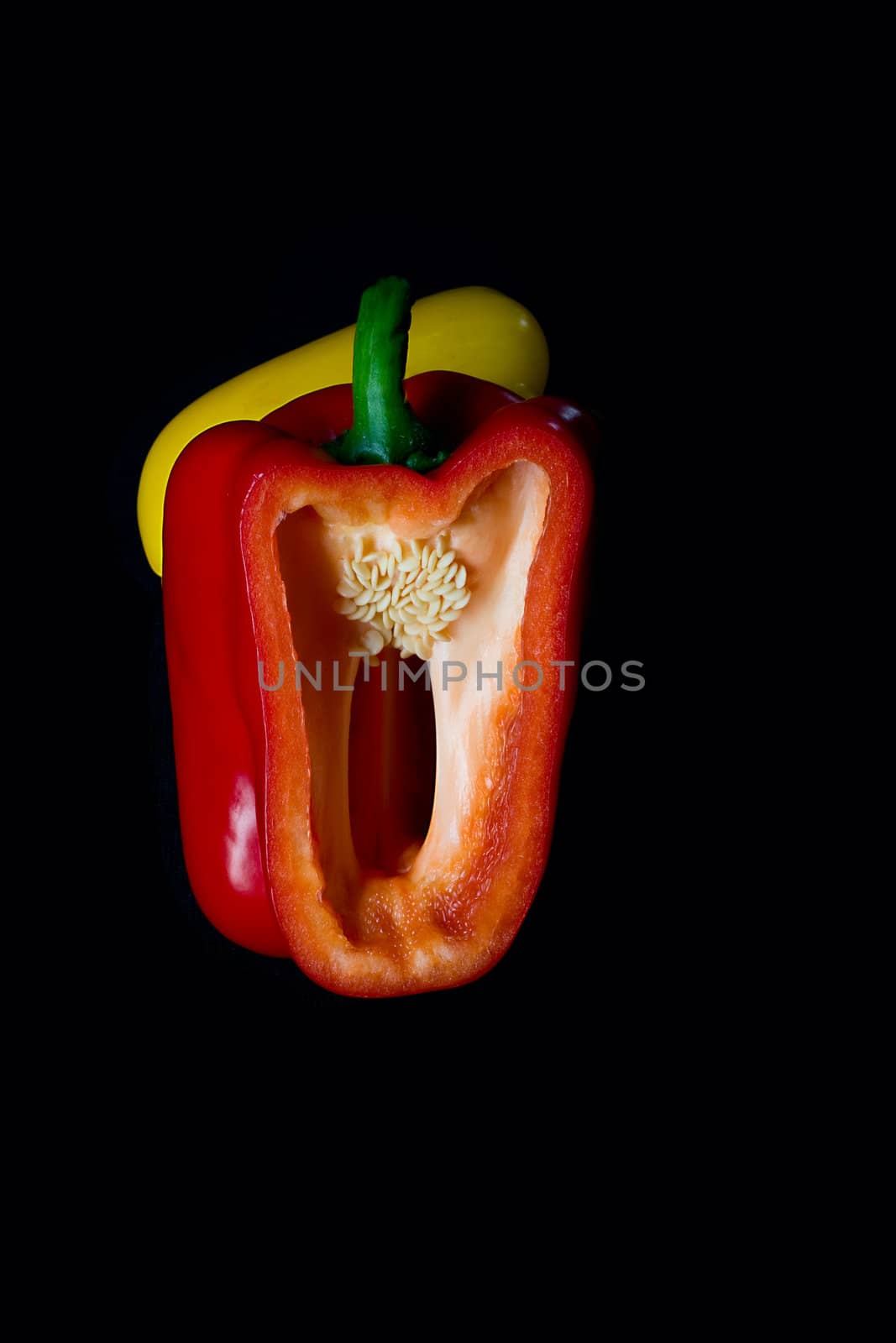 fresh red and yellow  pepper  on black background 