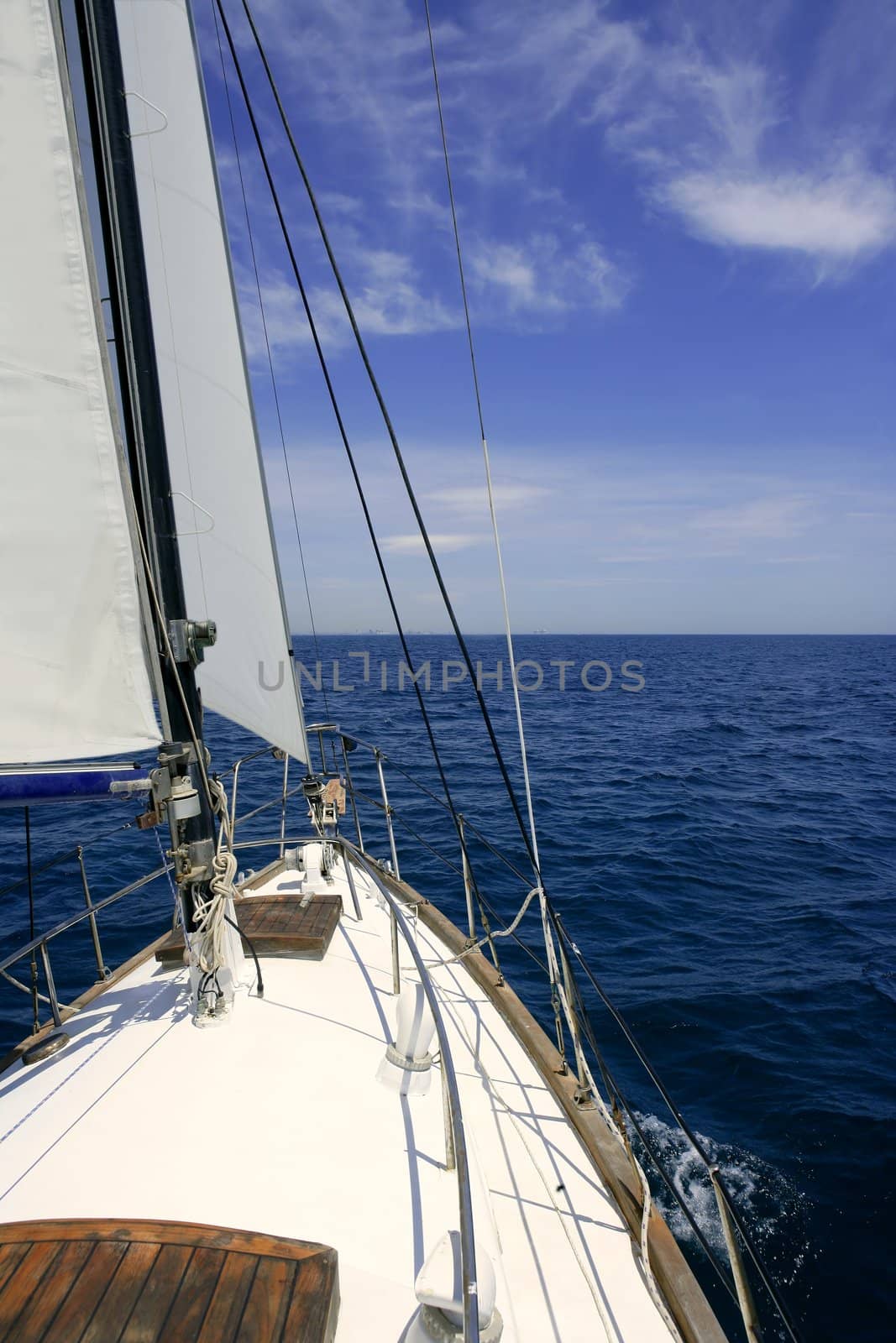 Sailboat sailing blue sea on sunny summer day in Mediterranean