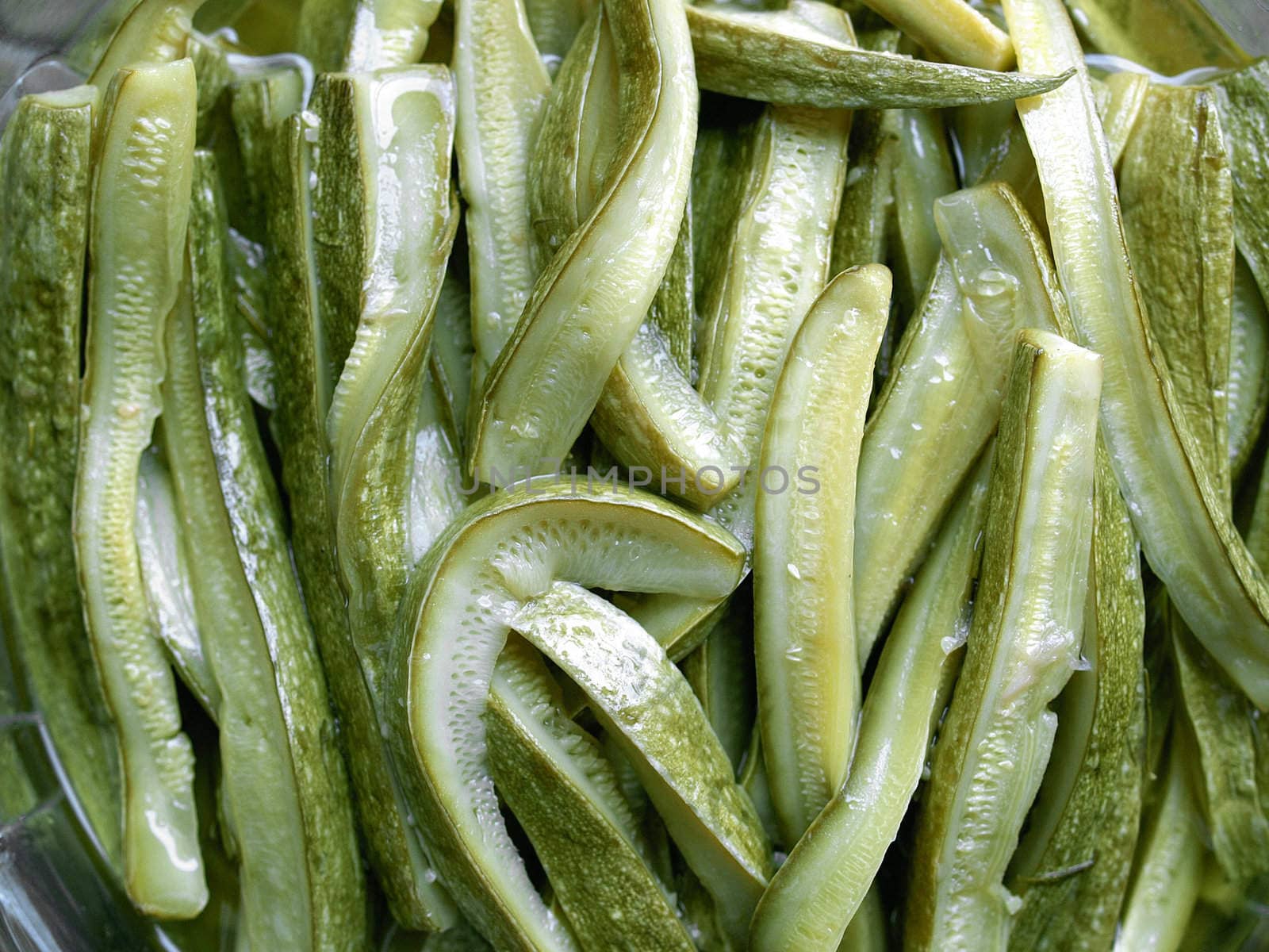 Green courgettes or zucchini vegetables useful as a background