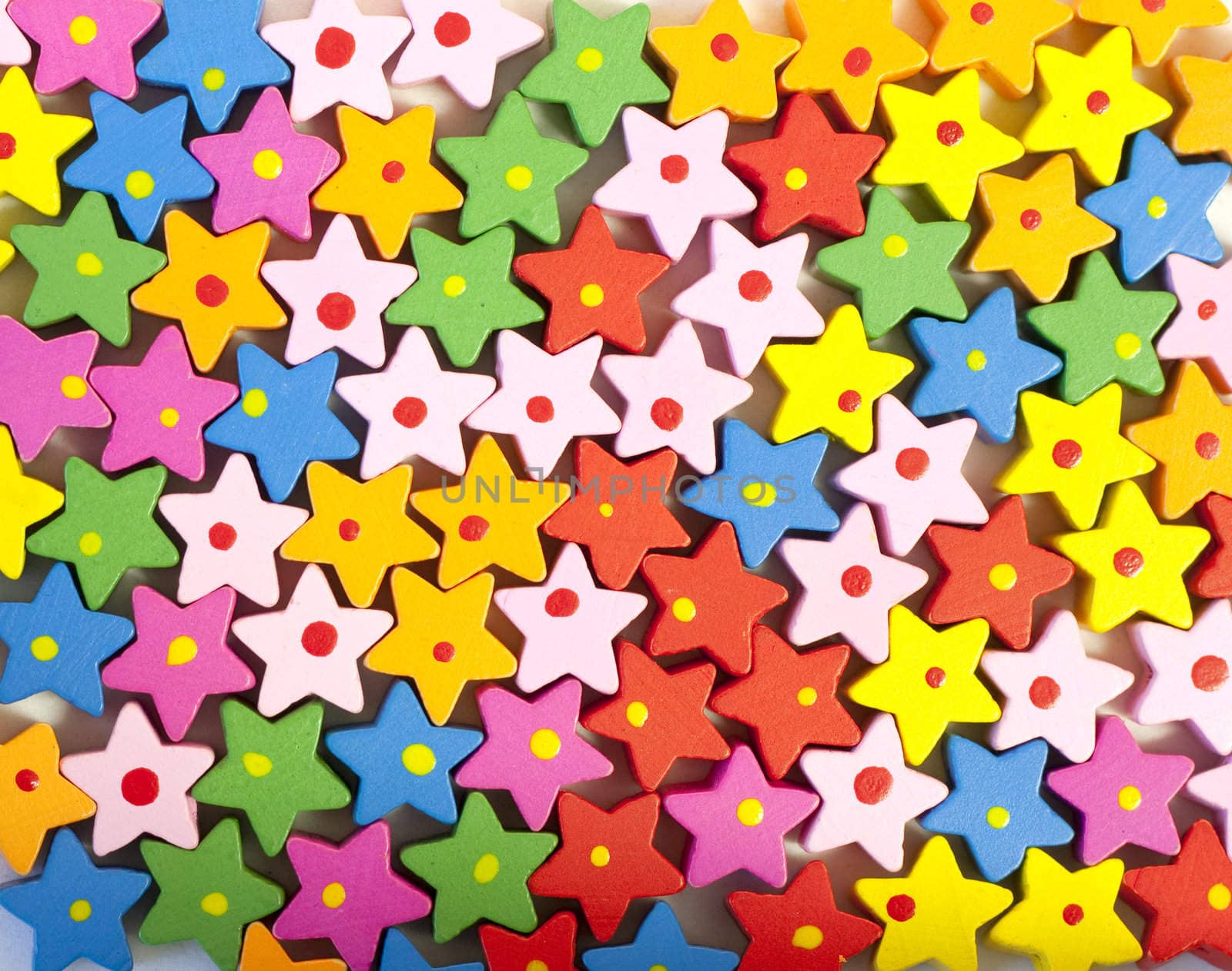 Background of many colorful painted wooden bead stars
