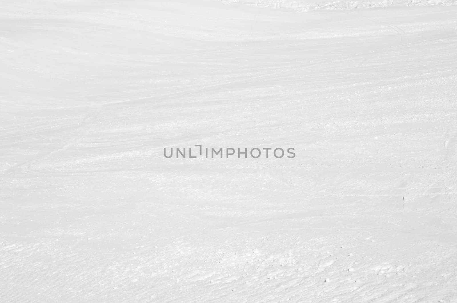 Clean white snowy background with faint ski tracks
