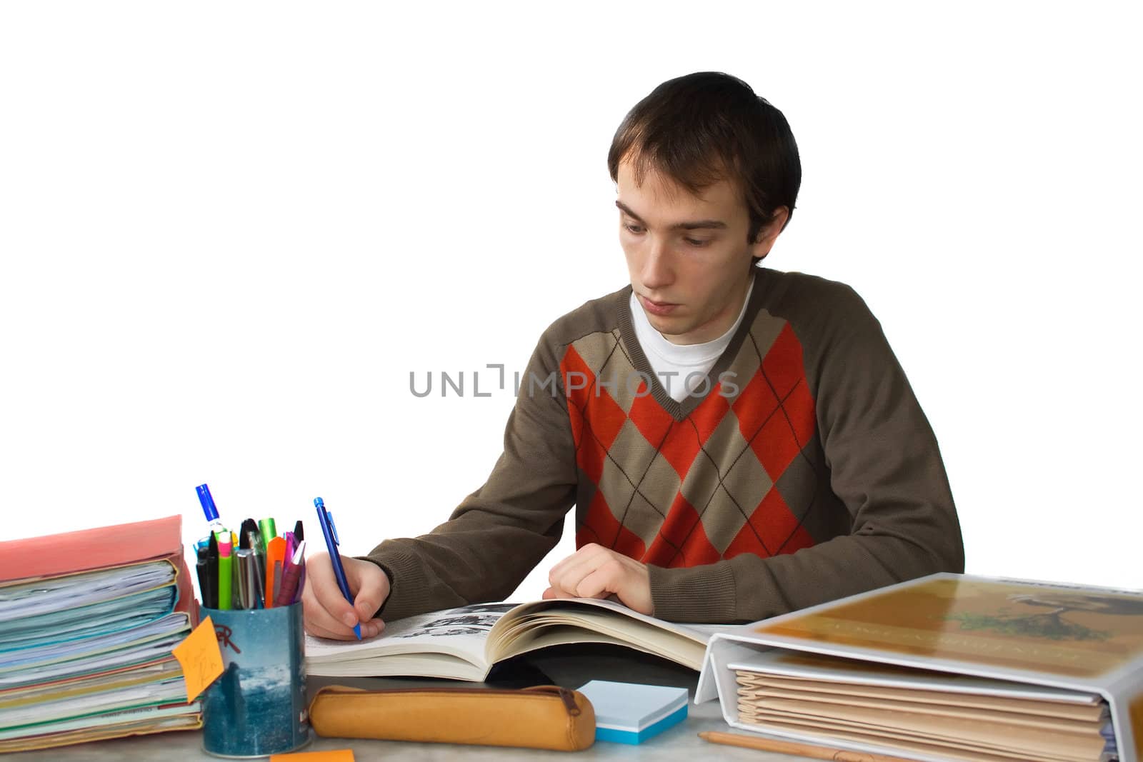 Male student writing at a table