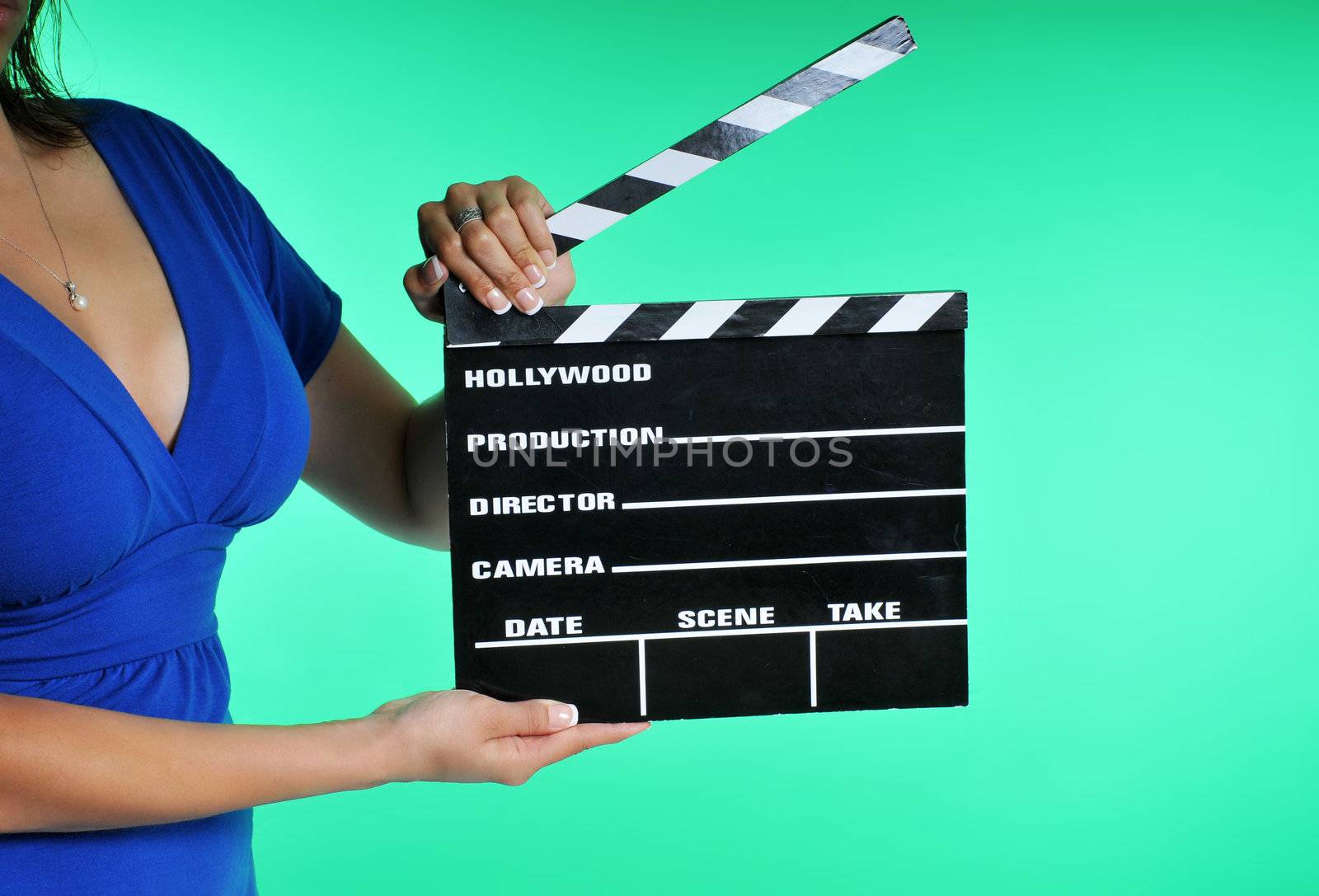 woman holding a clapper board on a green screen