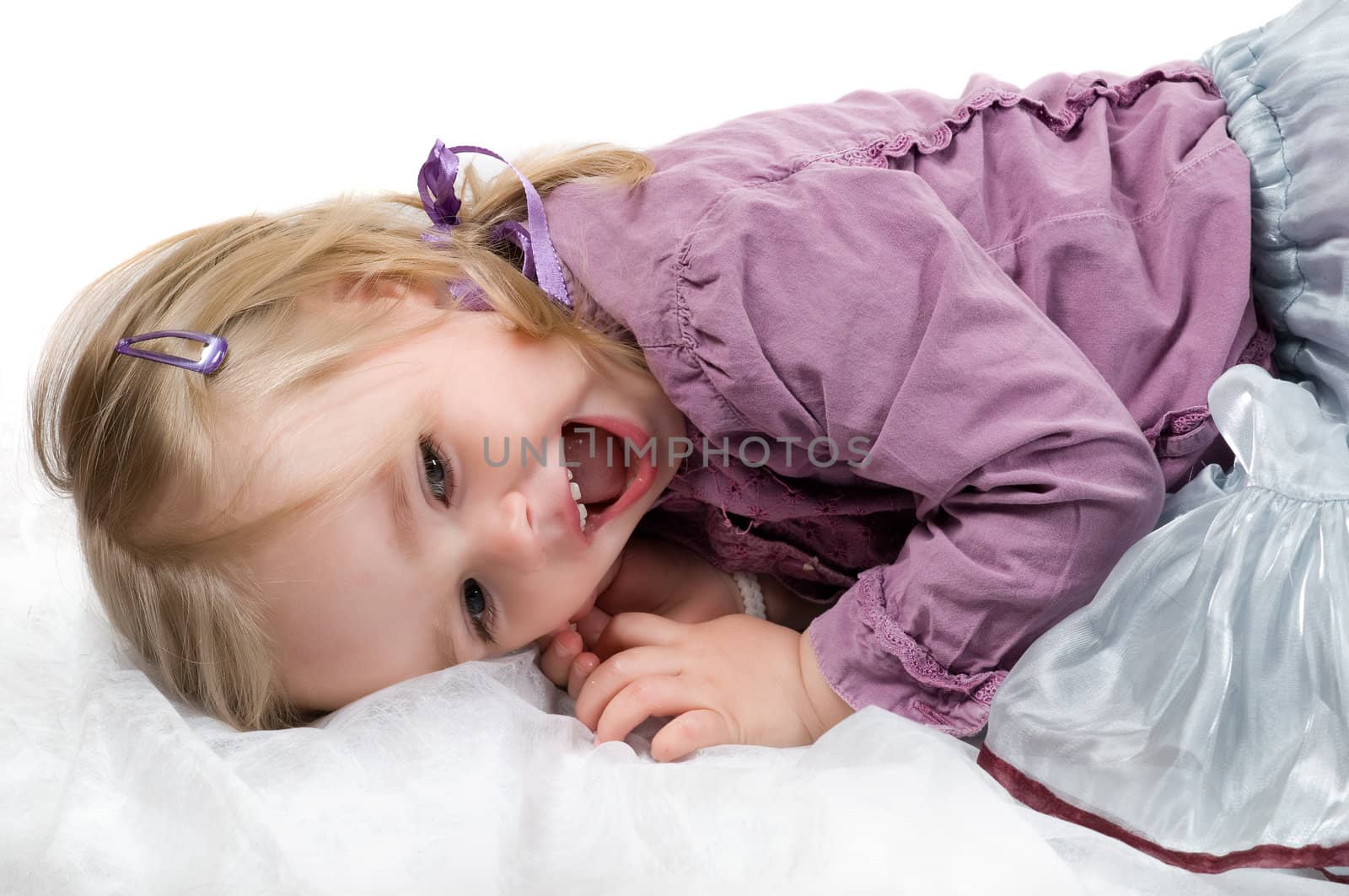 A little girl lying on the floor in studio