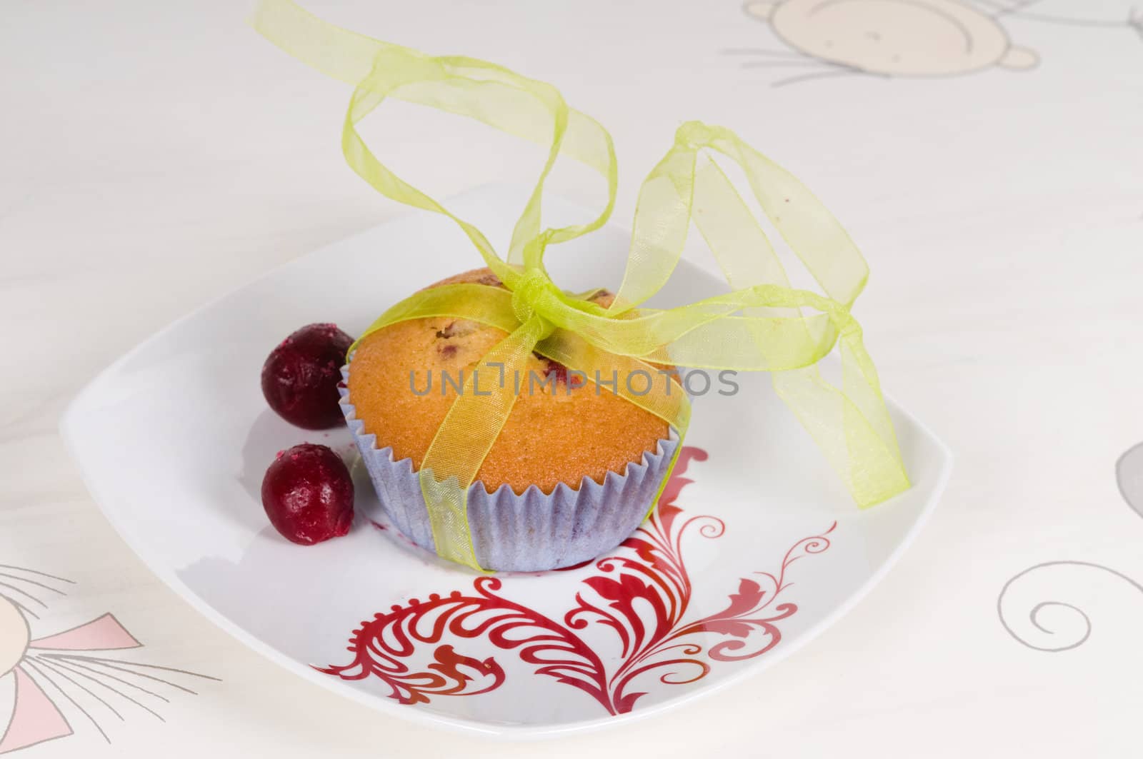 Cup-cakes on the table decorated with cherry