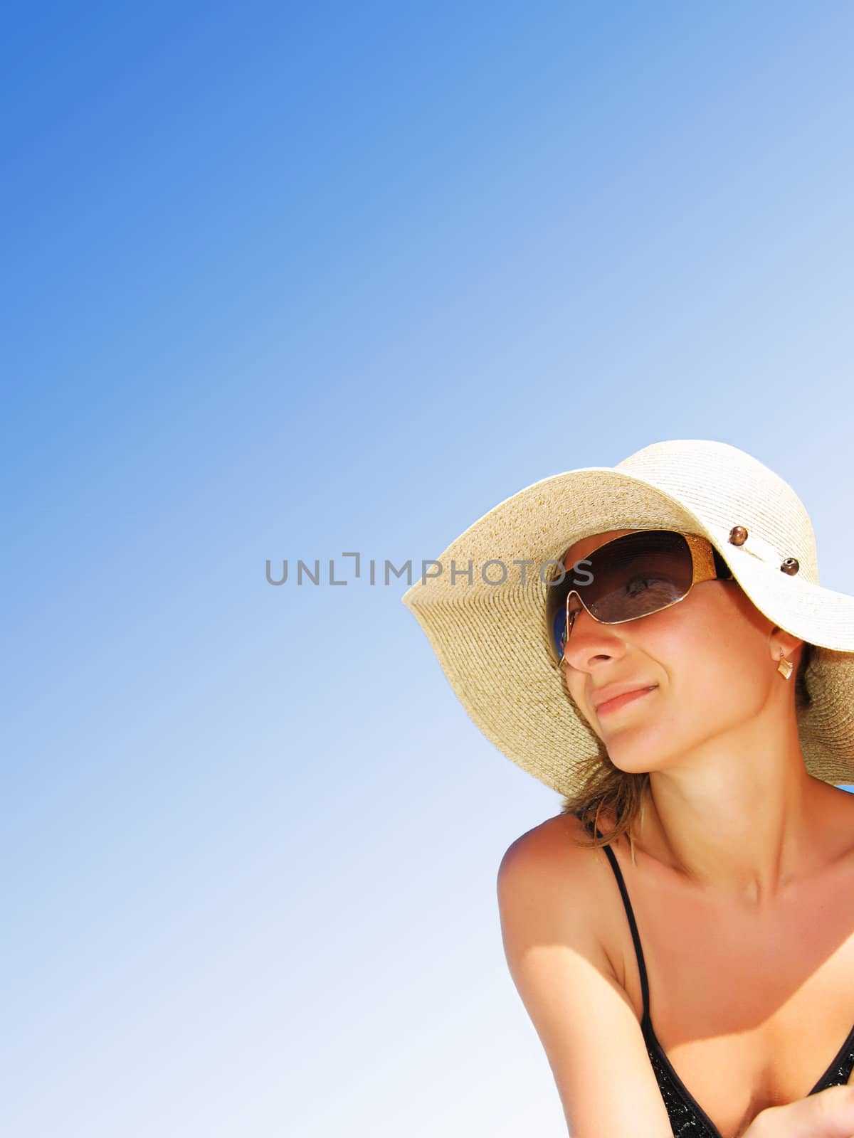 Woman with hat over blue gradient sky, place for copy-space