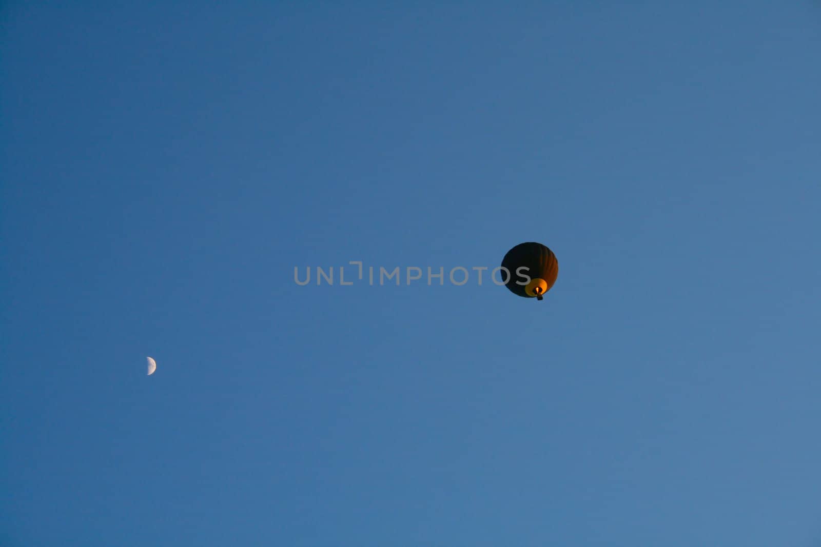 Balloon and moon on a background of pure blue sky