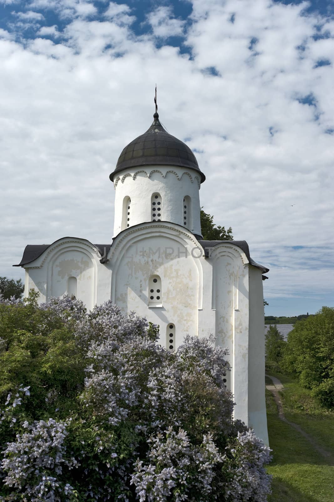 White stone russian church with lilac by mulden