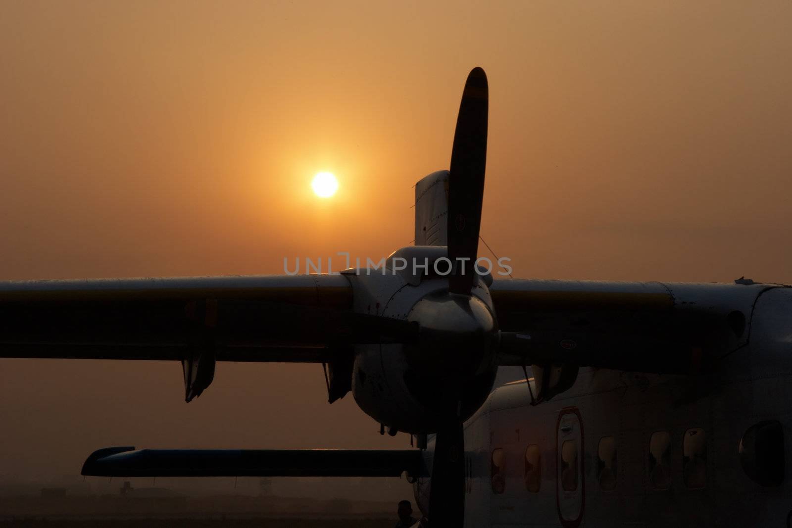 Plane at sunrise in Kathmandu airport, Nepal by azotov