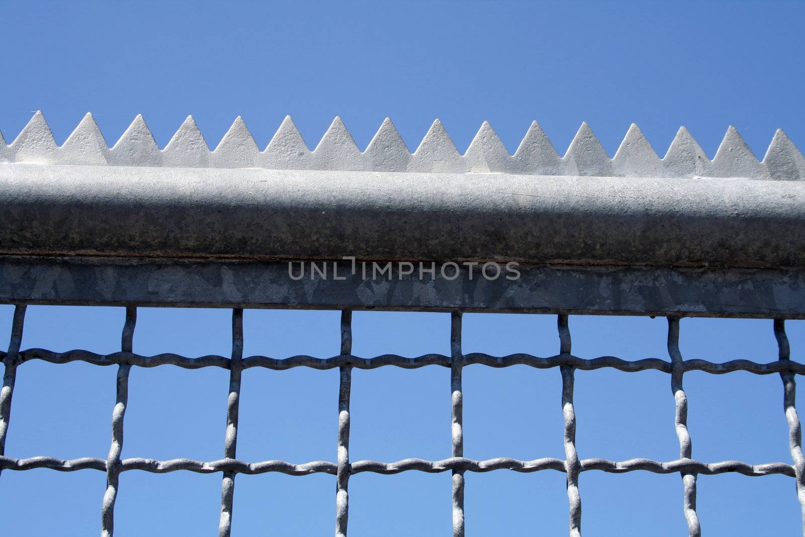 metal fence with with edges and tines