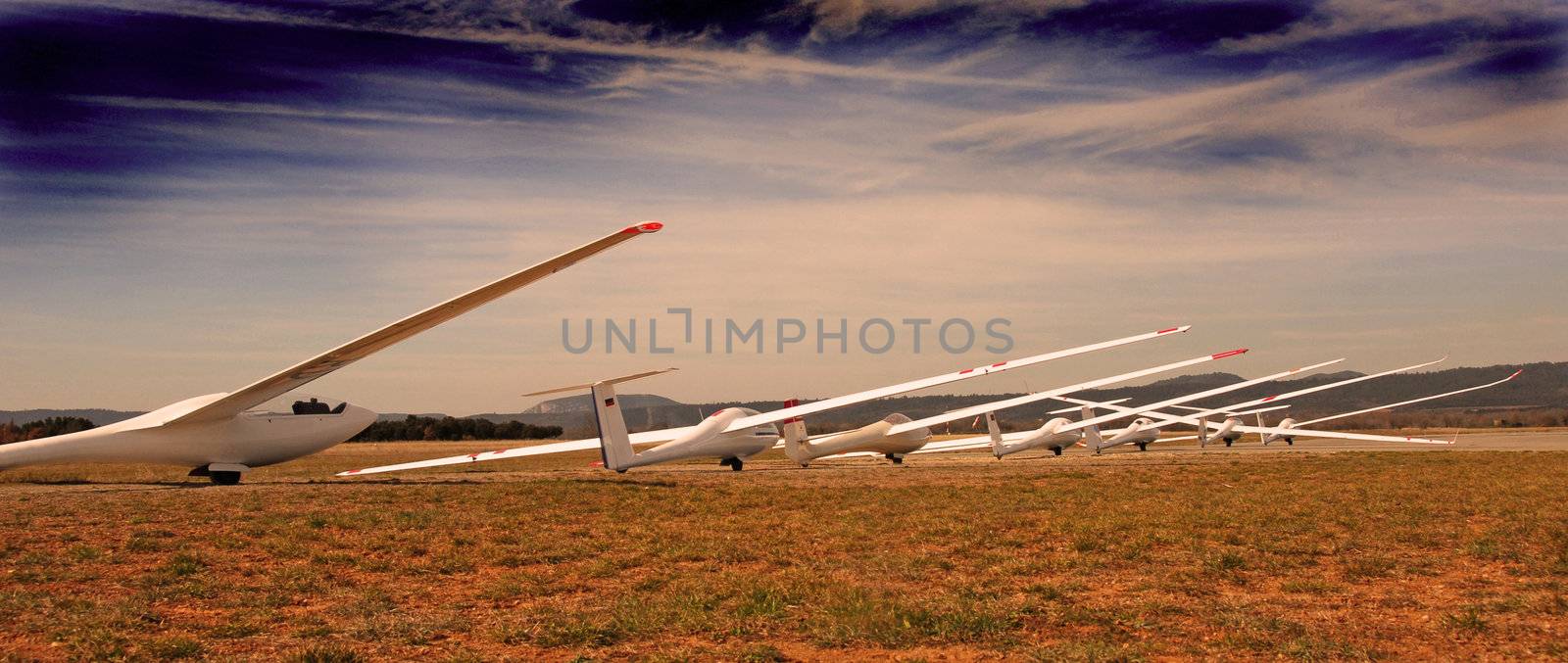seven white gliders in an aerodrome in south of France